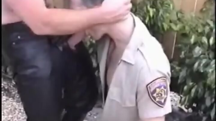 Cop sucks on leather penis